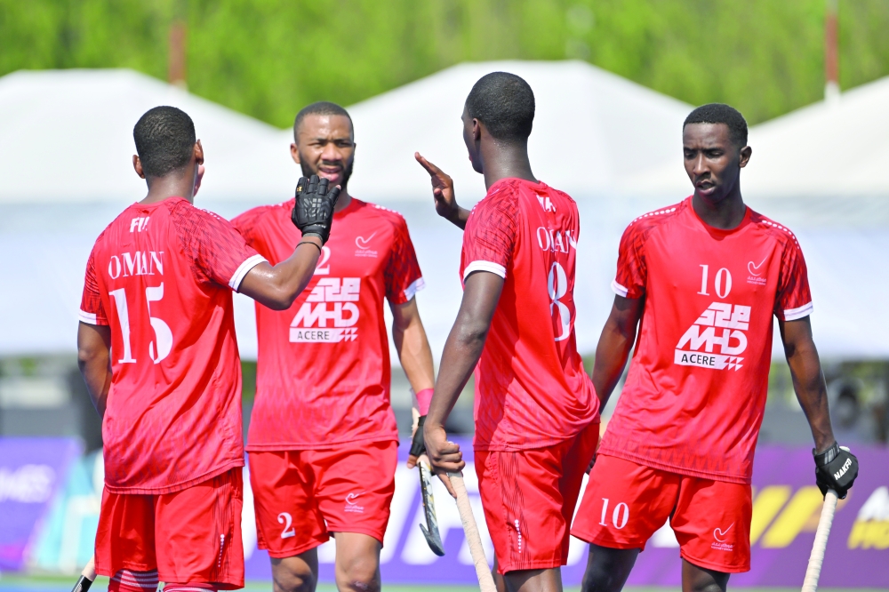 Oman players celebrate a goal against Kazakhstan.