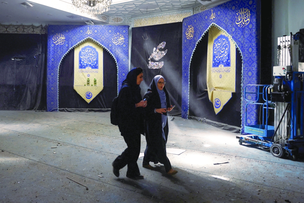 Women walk at a mosque at Sharif University of Technology, which was damaged in a strike, in Tehran. — Reuters