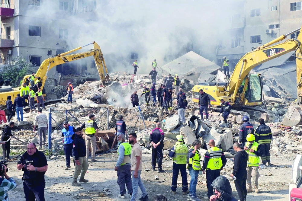 First responders rush to the site of an Israeli air strike, in southern Lebanese coastal city of Tyre. — AFP