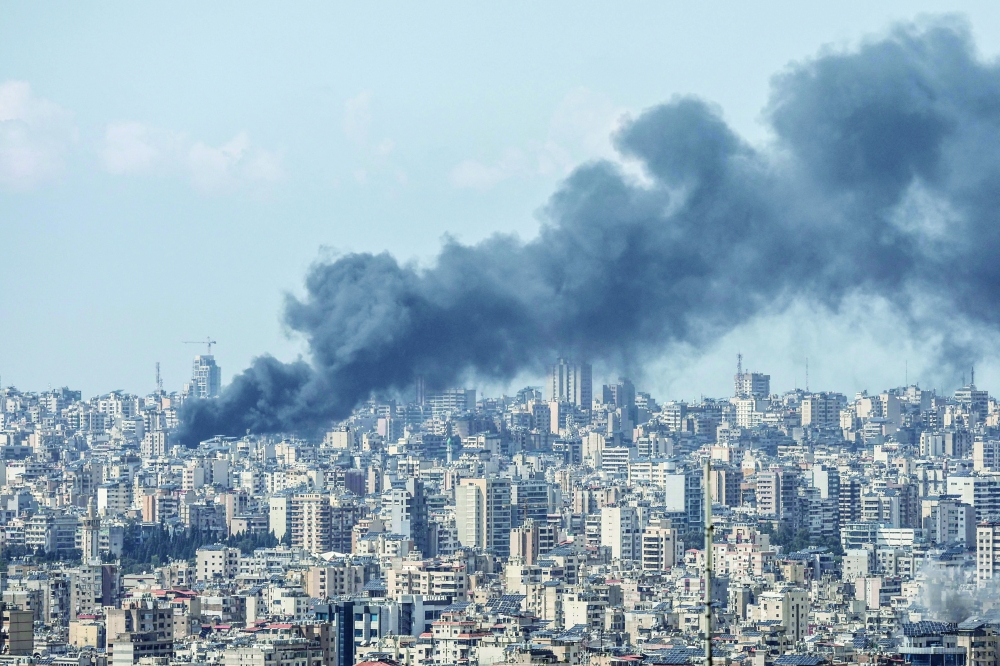 Smoke rises over Beirut following Israeli air strikes. — AFP