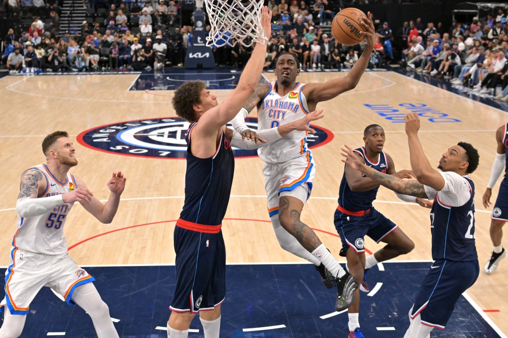 Oklahoma City Thunder guard Jalen Williams (8) drives past Los Angeles Clippers center Brook Lopez (11) for a basket