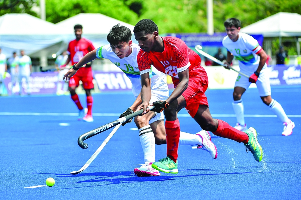 Oman and Uzbekistan players fight for the ball during the semifinal of the Asian Games Qualifier in Bangkok.