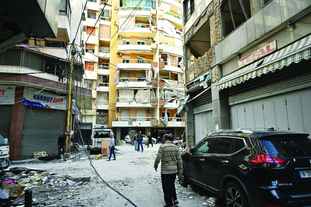People inspect the site of an Israeli air strike the day after striking the Basta neighbourhood of Beirut. — AFP