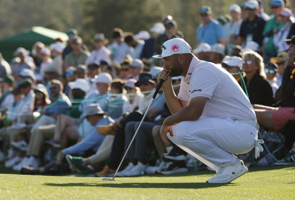  Spain's Jon Rahm lines up a putt on the green of the 18th hole during the first round 