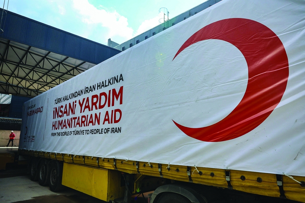 Truck of The Red Cross and Türkiye's Red Crescent ready to send supplies to Iran, in Ankara. — AFP
