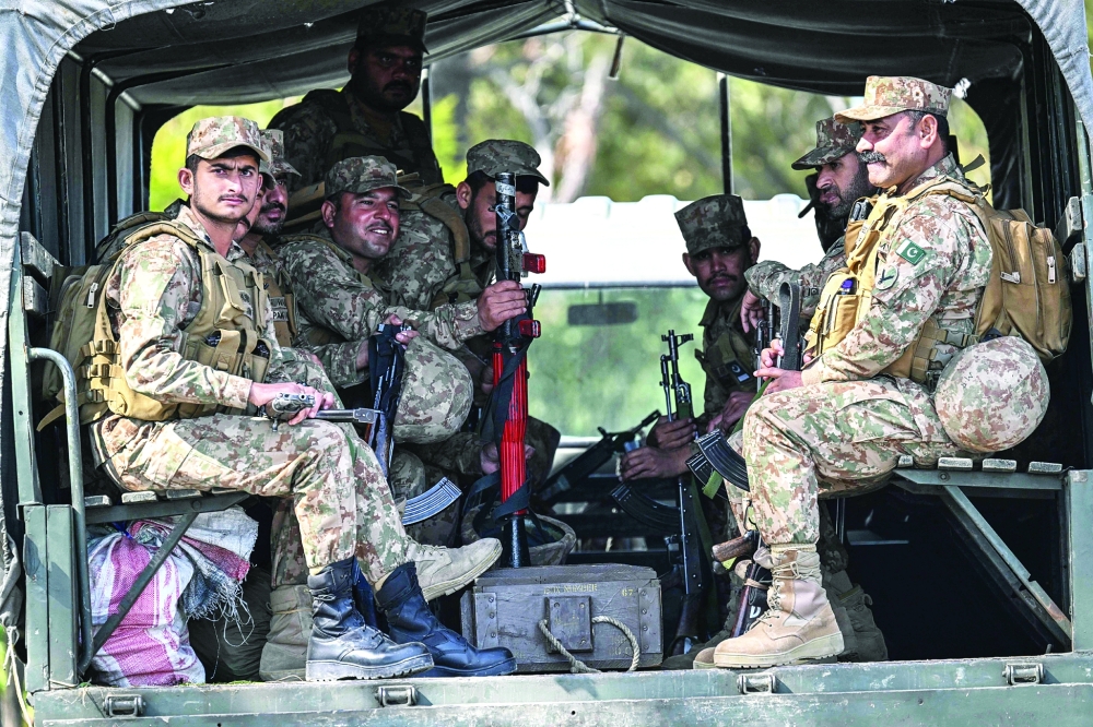 Pakistani army soldiers arrive for deployment at the Red Zone area of Islamabad. — AFP