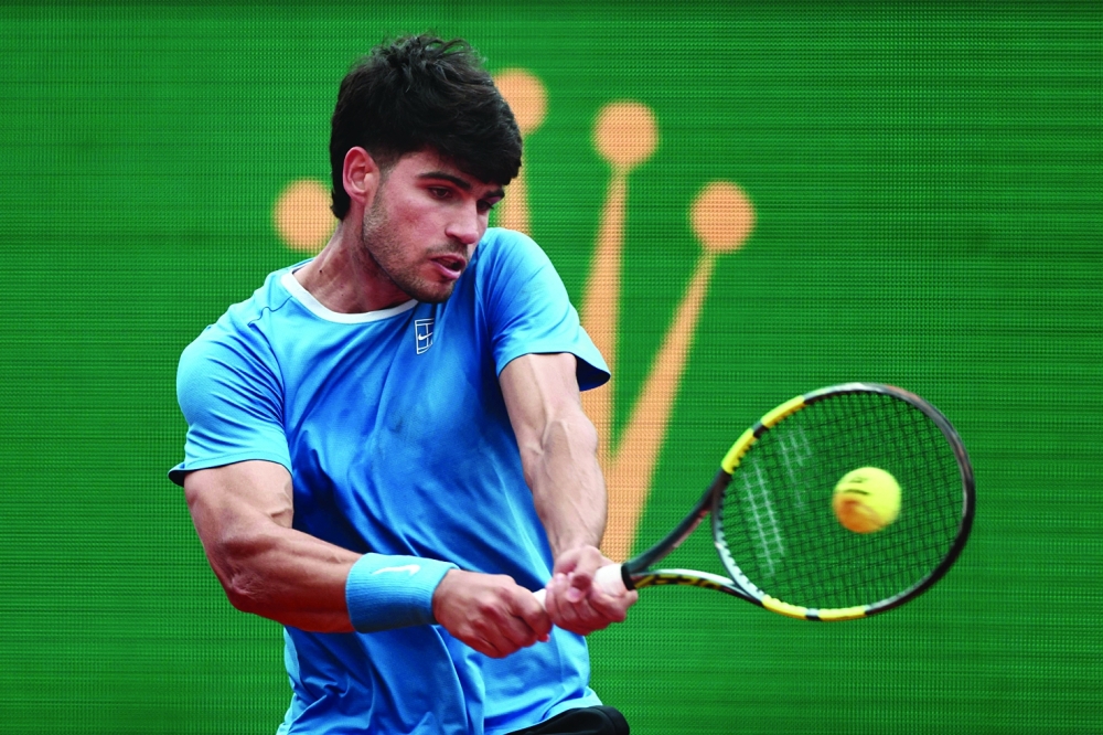Spain's Carlos Alcaraz plays a backhand return to Kazakhstan's Alexander Bublik during the Monte Carlo ATP Masters Series Tournament quarter final tennis match on Court Rainier III at the Monte-Carlo Country Club in Roquebrune-Cap-Martin, south-eastern France on April 10, 2026. (Photo by Thibaud MORITZ / AFP)
