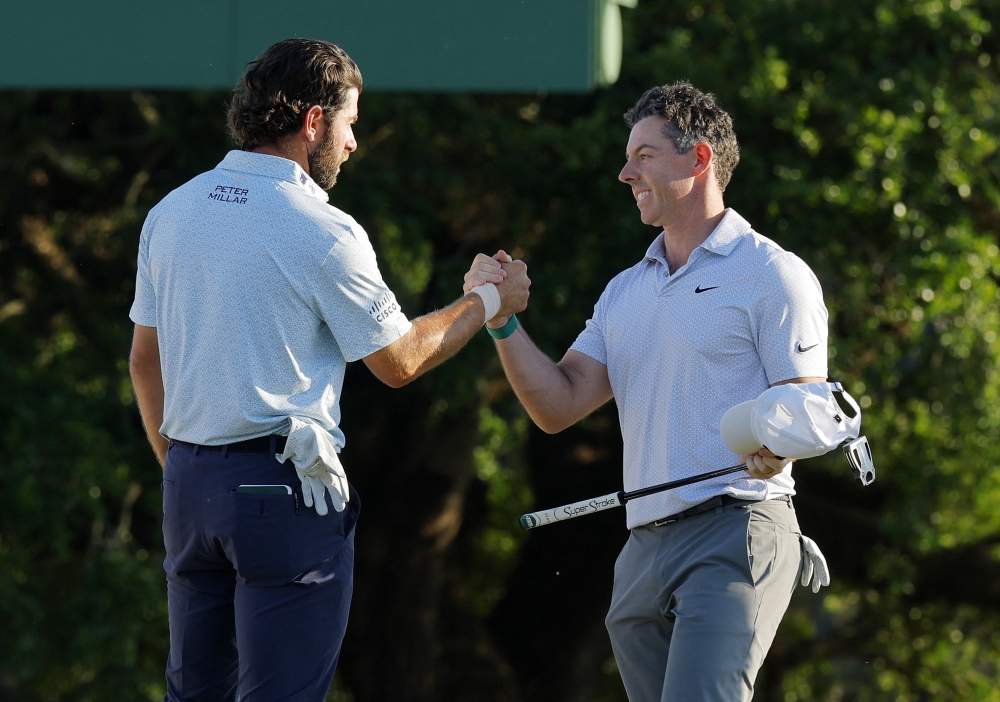  Northern Ireland's Rory McIlroy shakes hands with Cameron Young of the U.S. on the 18th hole