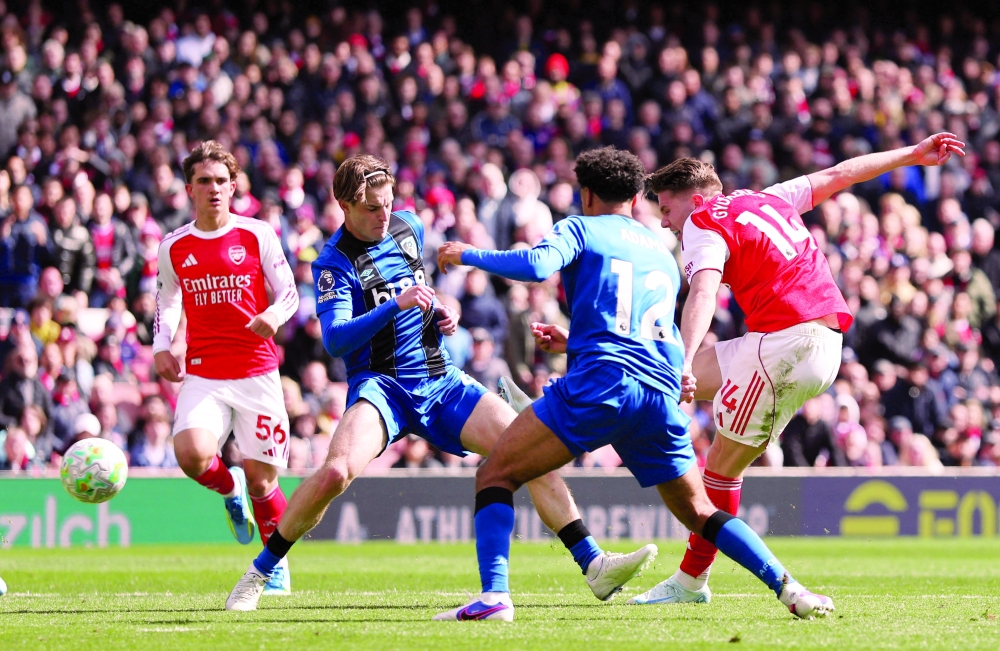 Arsenal's Viktor Gyokeres in action with AFC Bournemouth's Alex Scott and Tyler Adams as he shoots at goal Action. — Reuters