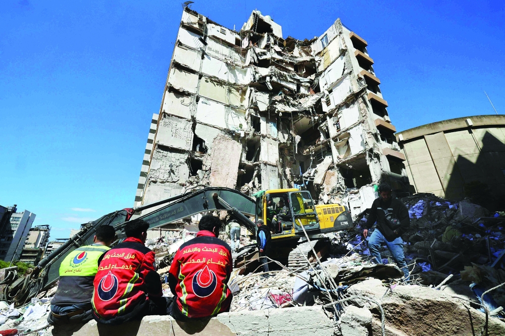 Lebanese rescuers clear the rubble at the site of an Israeli air strike, in Beirut. — AFP