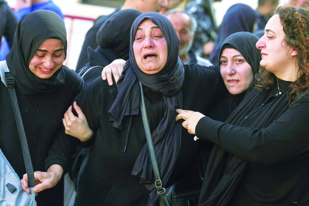 Mourners react on the day of a reception ceremony for the bodies, in Sidon. — Reuters 