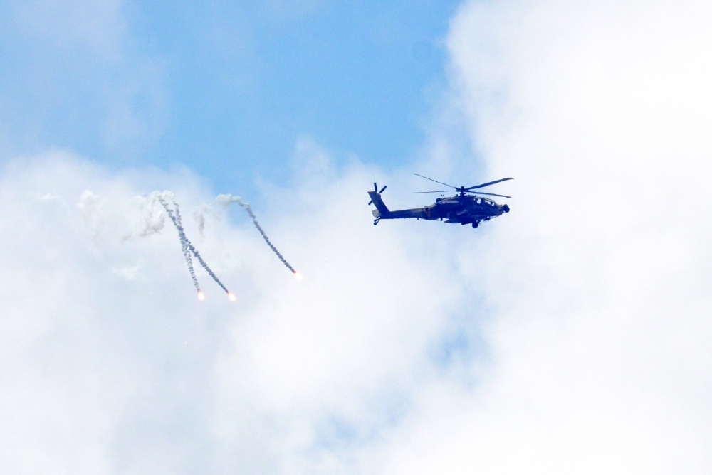 An Israeli Apache helicopter releases flares as it flies over Lebanon. — Reuters 