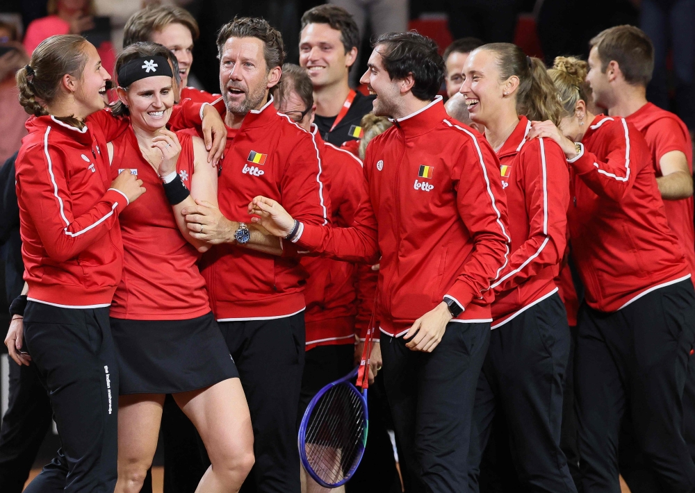(LtoR) Belgium's Hanne Vandewinkel, Greet Minnen, team captain Wim Fissette and Elise Mertens celebrate after the winning  

