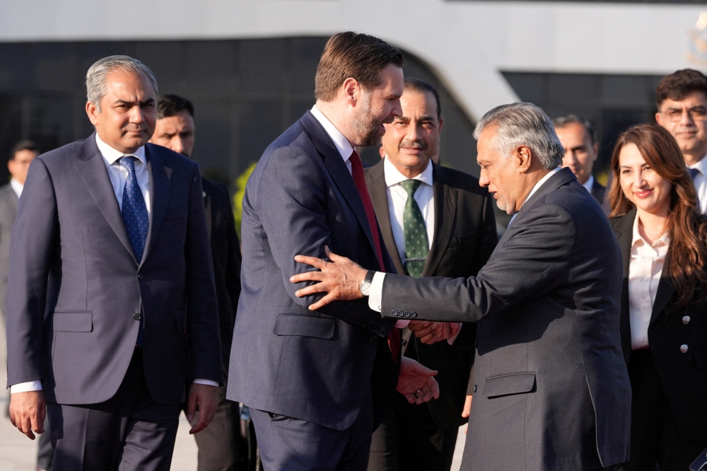 U.S. Vice President JD Vance shakes hands with Pakistani Deputy Prime Minister and Foreign Minister Mohammad Ishaq Dar, as Vance prepares to board Air Force Two, after peace talks with Iran in Islamabad, Pakistan, Sunday, April 12, 2026. Jacquelyn Martin/Pool via REUTERS     TPX IMAGES OF THE DAY