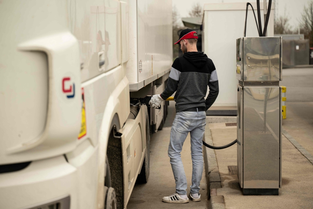 (FILES) A man fills in the tank of his truck at a gas station on March 16, 2022 in Savenay, western France. The increase in fuel prices due to the situation in the Middle East has led to a surge in fuel theft from truckers’ tanks. (Photo by Loic VENANCE / AFP)
