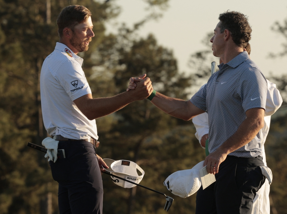   Sam Burns of the U.S. shakes hands with Northern Ireland's Rory McIlroy on the 18th hole after finishing their third round  