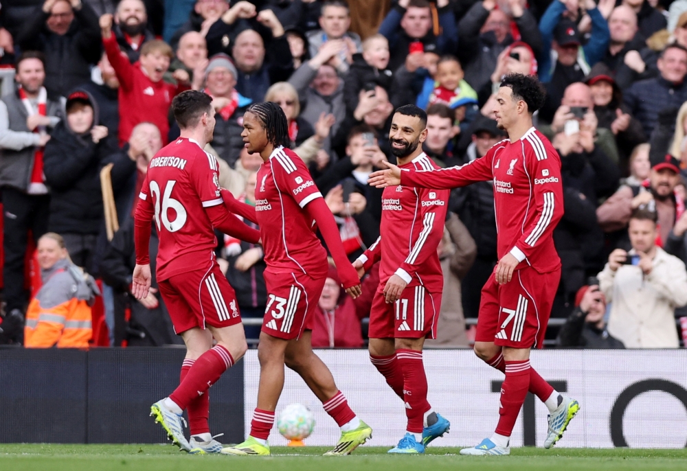   Liverpool's Mohamed Salah celebrates scoring their second goal with teammates  