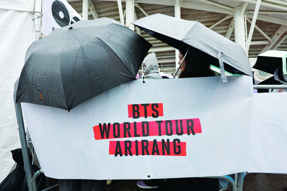 Fans of K-pop boy band BTS, known as ARMY, wait in line to enter the concert venue ahead of the band's first world‑tour concert "ARIRANG" in more than three years, at Goyang stadium in Goyang. — Reuters