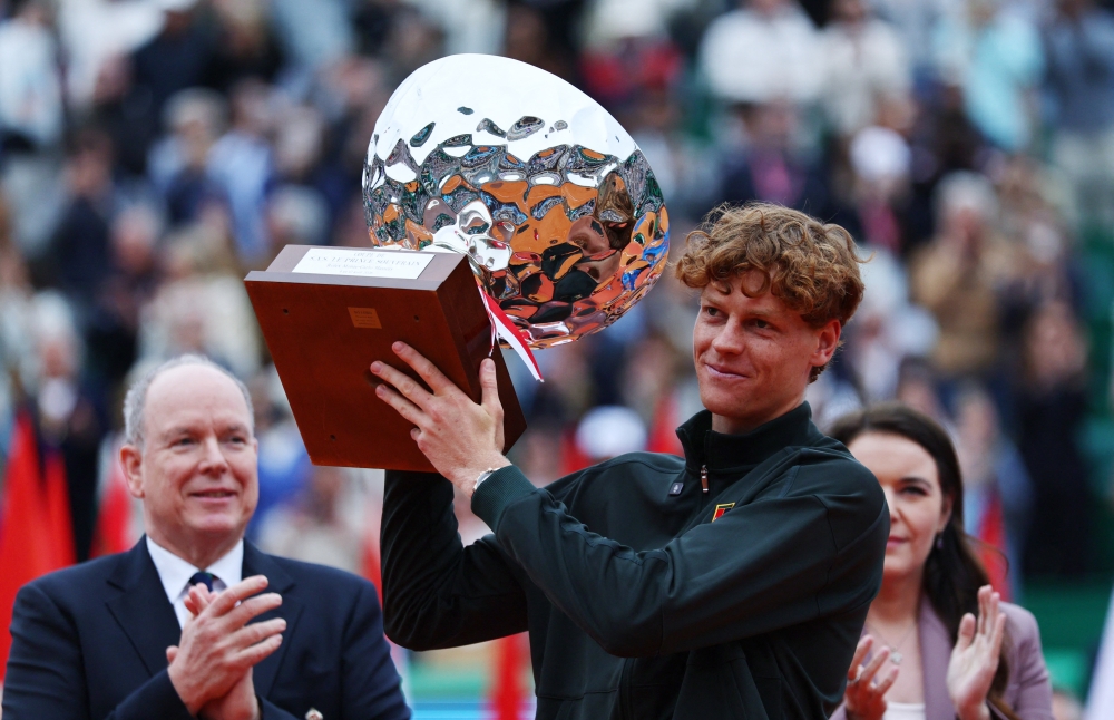 Italy's Jannik Sinner celebrates with the trophy after winning his final match against Spain's Carlos Alcaraz. — Reuters
