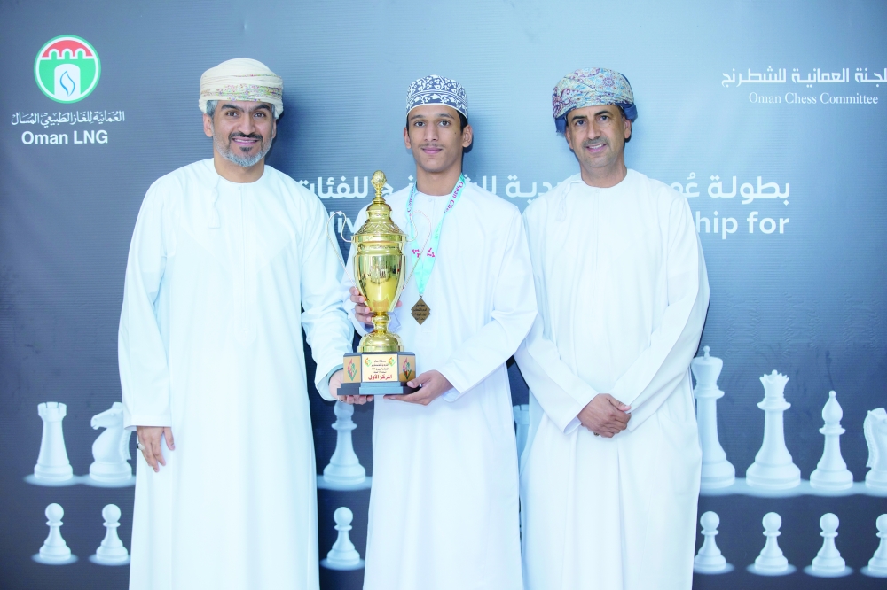  One of the champions receives his trophy during the award ceremony of the Oman Individual Chess Championship for Age Groups.
