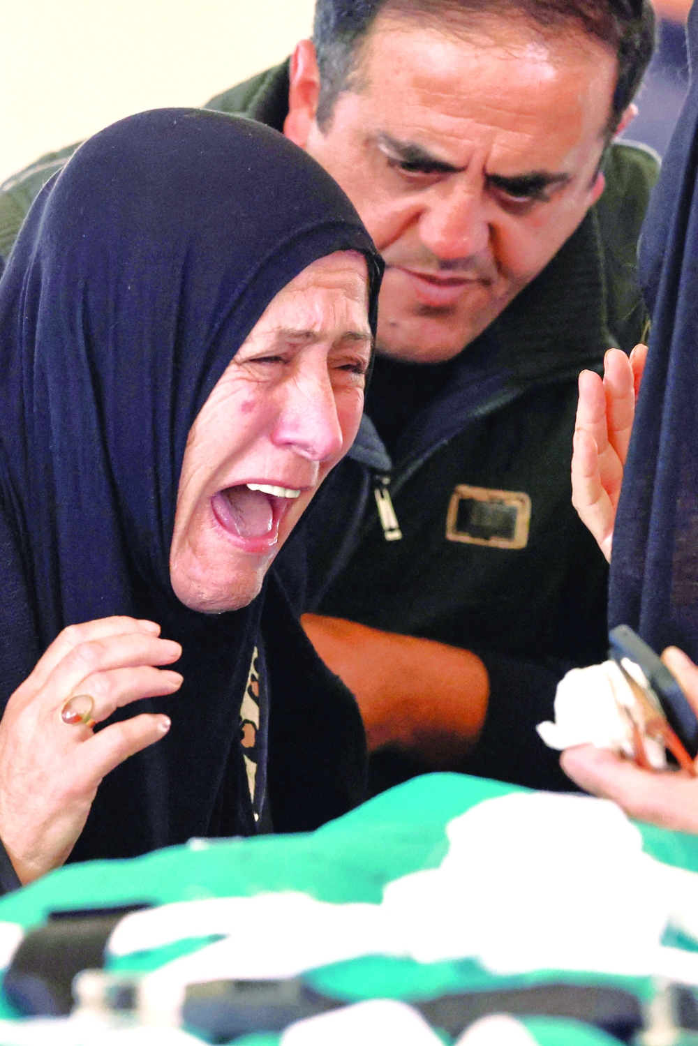 Relatives mourn over the bodies of four members of the Saeed family killed in an Israeli strike in the village of Srifa, at the Al Kharab mosque in Tyre, Lebanon, on Sunday. — Reuters