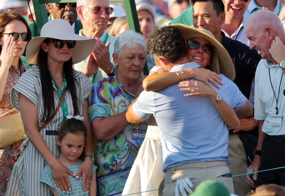 Rory McIlroy celebrates with his is daughter Poppy, wife Erica Stoll, mother Rosie McDonald and father Gerry McIlroy after winning The Masters  