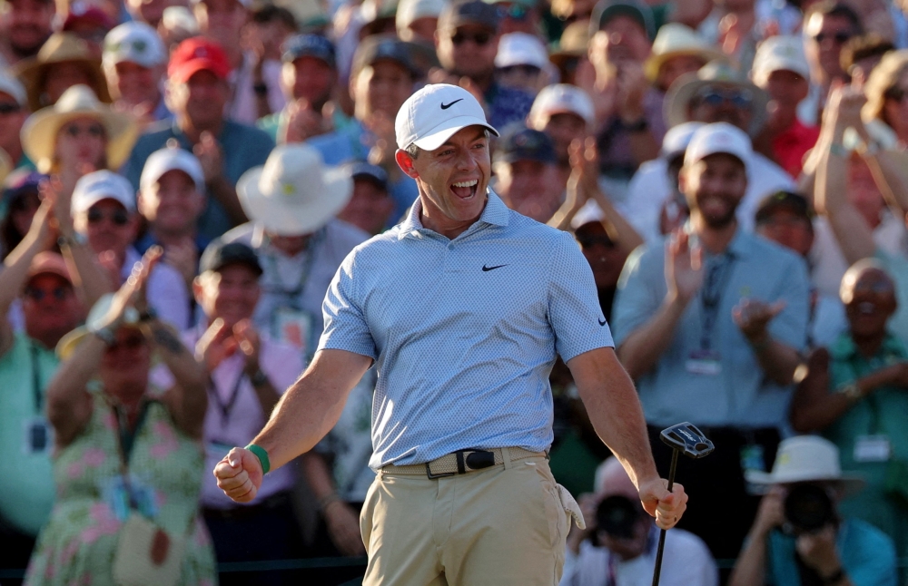  Northern Ireland's Rory McIlroy celebrates on the green on the 18th hole after winning The Masters 