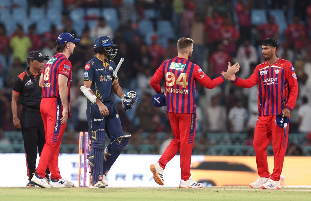 Washington celebrates after the match as Lucknow Super Giants' Aiden Markram shakes hands with Mukul Choudhary 