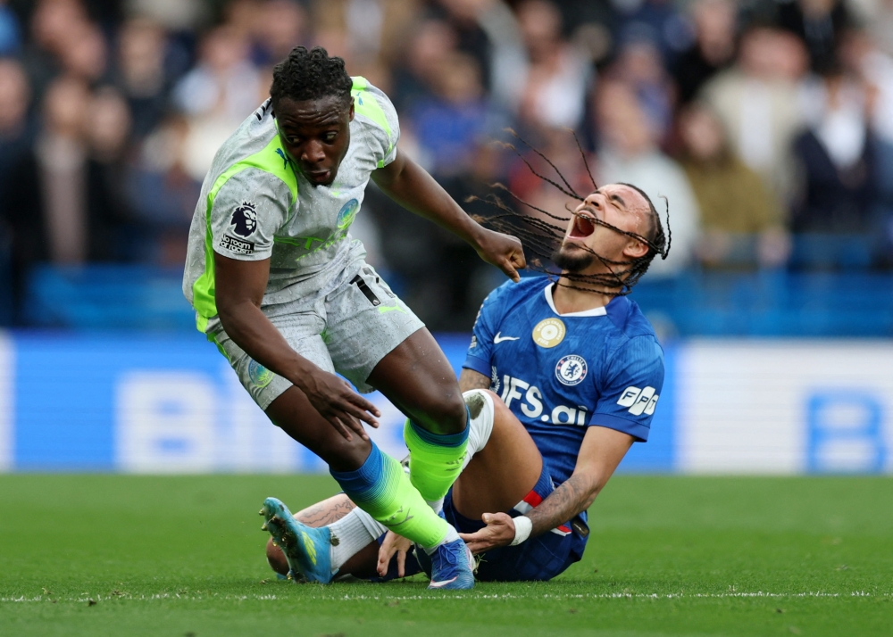 Chelsea's Malo Gusto in action with Manchester City's Jeremy Doku 