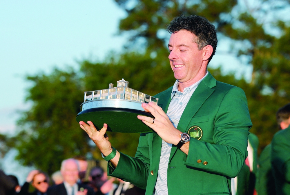  Northern Ireland's Rory McIlroy celebrates with his green jacket and the trophy after winning The Masters. — Reuters