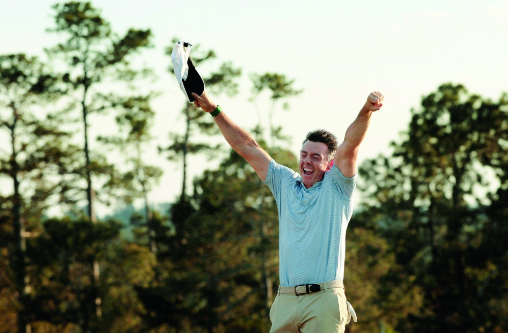  Northern Ireland's Rory McIlroy celebrates on the green on the 18th hole after winning The Masters. — Reuters