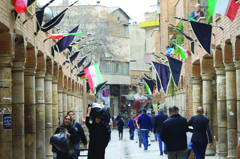 Shoppers walk through Grand Bazaar in Tehran, Iran. — Reuters 