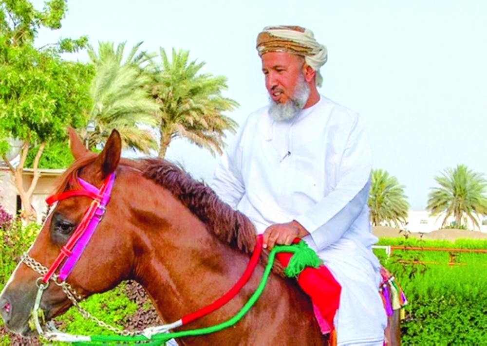 Salim bin Said al Rashidi, owner of Al Mahamid Stud Farm, with one of the horses born at the farm.