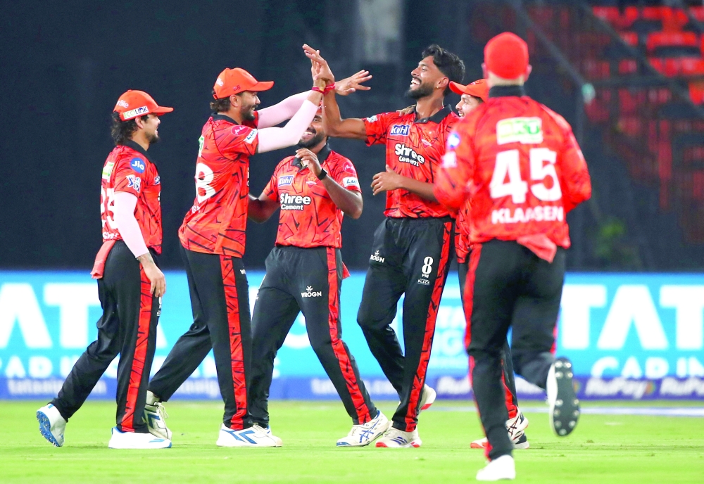 Sunrisers Hyderabad's Praful Hinge celebrates the wicket of Rajasthan Royals' Lhuan-dre Pretorius with teammates. — Reuters  