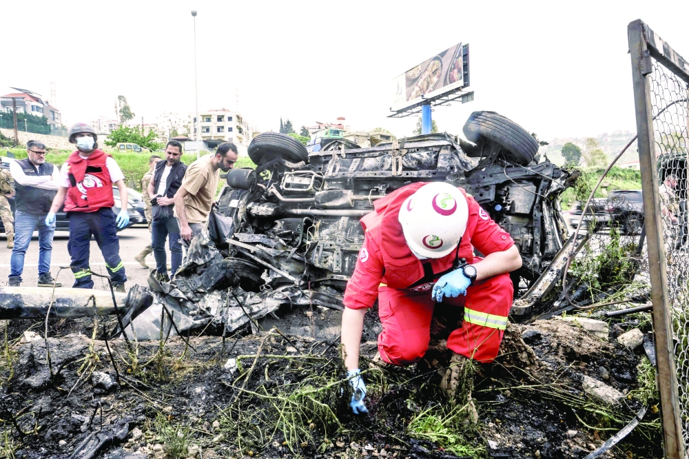 First responders inspect the site of an Israeli air strike, south of Beirut. — AFP