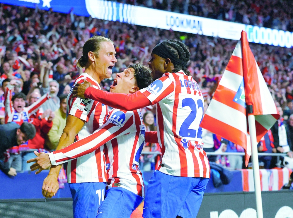 Atletico Madrid's Ademola Lookman celebrates scoring their first goal with Marcos Llorente and Giuliano Simeone. — Reuters
