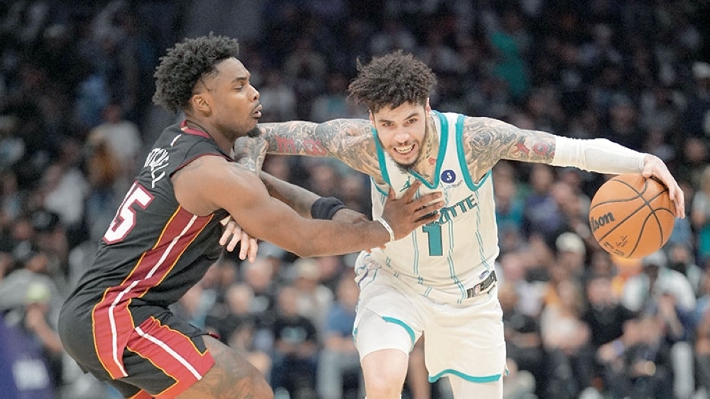 Charlotte Hornets' LaMelo Ball (1) moves the ball against Miami Heat's Davion Mitchell (45) during the play-in rounds of the 2026 NBA Playoffs at Spectrum Center. — Imagn Images