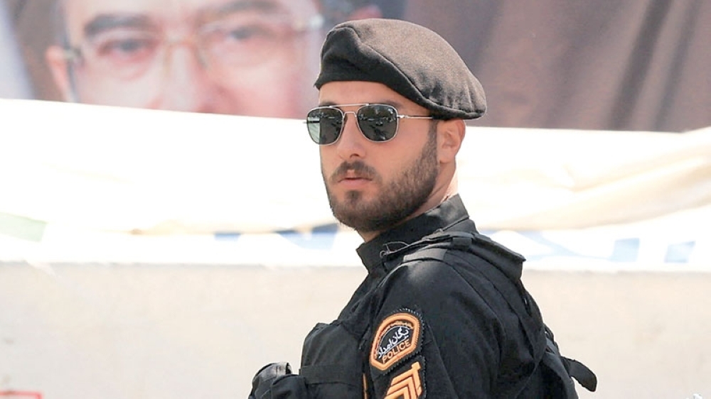 A police officer stands guard on a street, amid a ceasefire between the US and Iran, at Tajrish Square in Tehran, Iran, on Wednesday. - Reuters