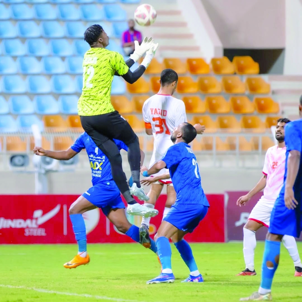 Players rise for an aerial challenge during the Oman Club-Al Nasr match.