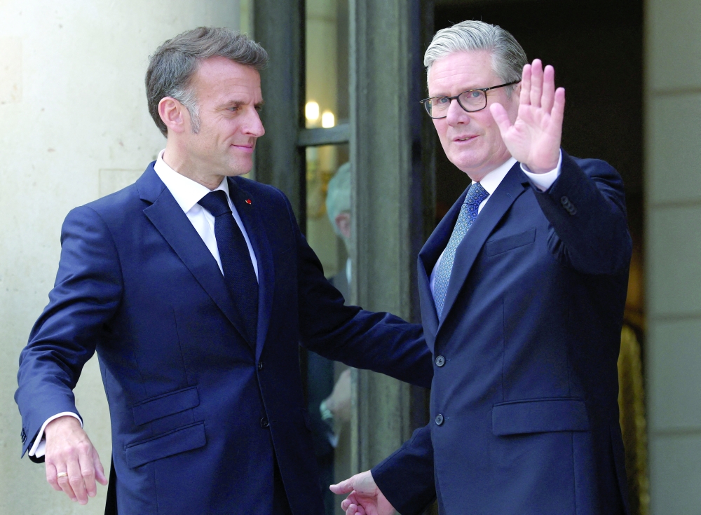 French President Emmanuel Macron greets British Prime Minister Keir Starmer, ahead of multinational virtual summit at the Elysee Presidential Palace in Paris. — Reuters