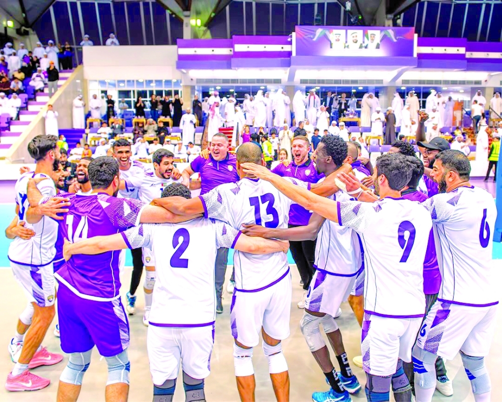 Al Ain players and support staff celebrate after winning the UAE Cup final.