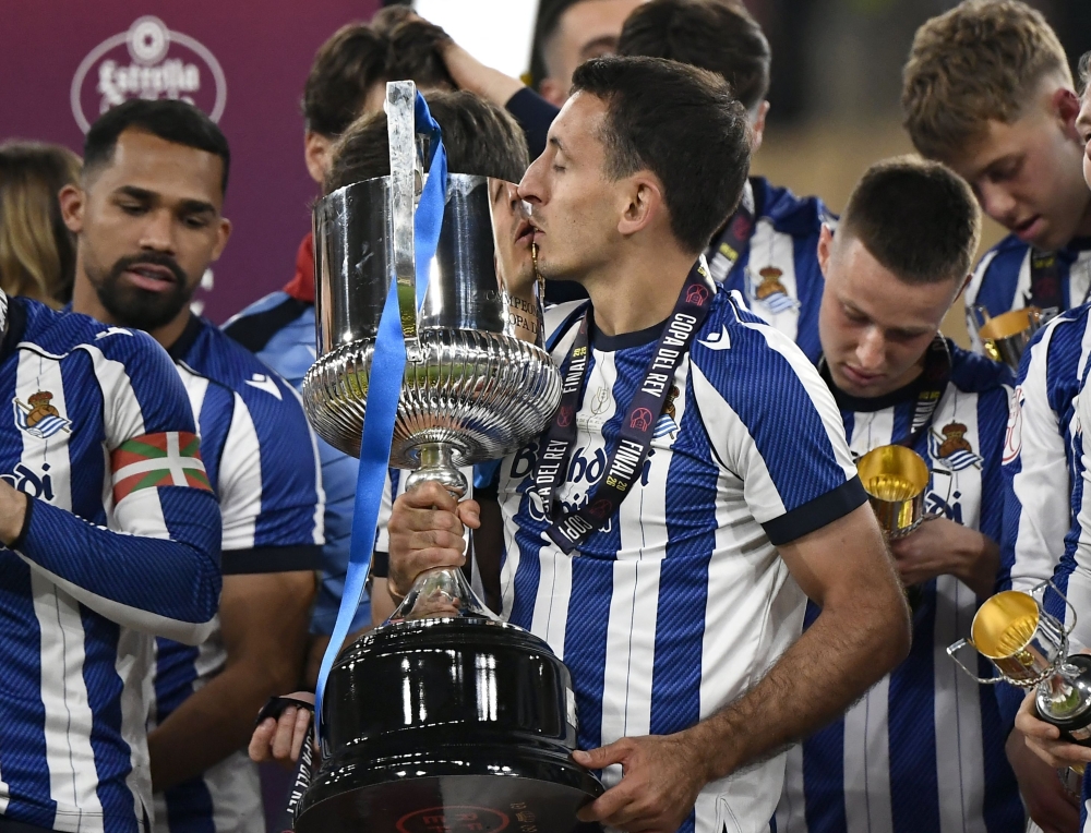 TOPSHOT - Real Sociedad's Spanish forward #10 Mikel Oyarzabal celebrates with the trophy at the end the Copa del Rey (King's Cup)  