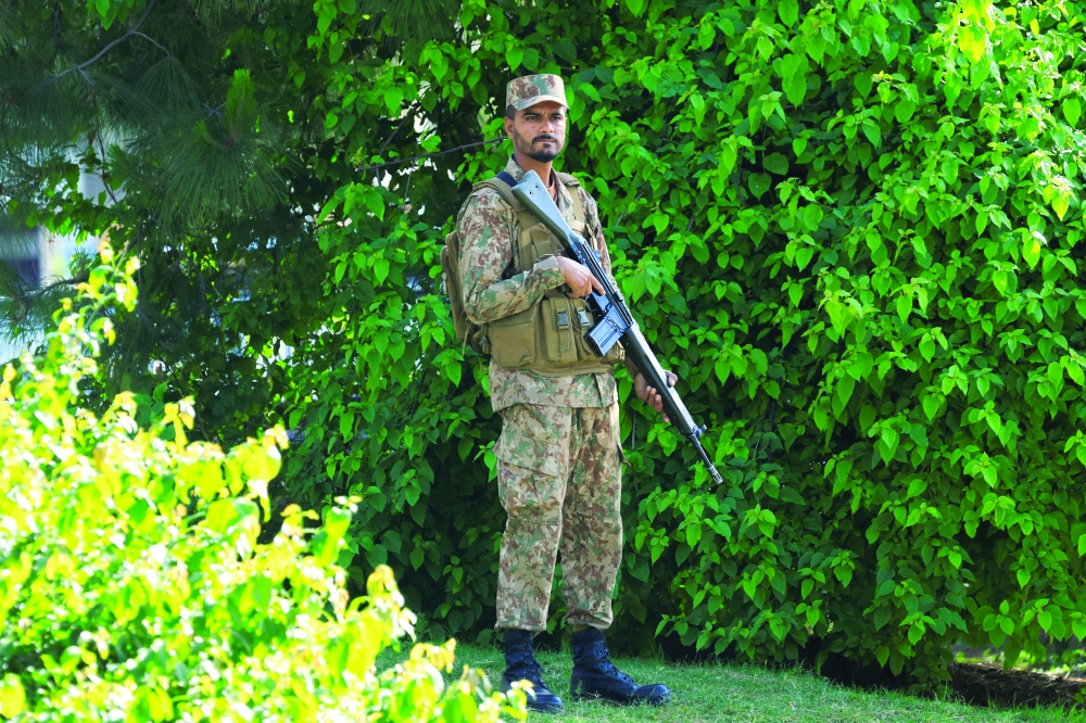 A Pakistani army soldier stands guard at D Chowk near the President's House as Pakistan prepares to host the United States and Iran for the second phase of peace talks in Islamabad, Pakistan, on Sunday. - Reuters