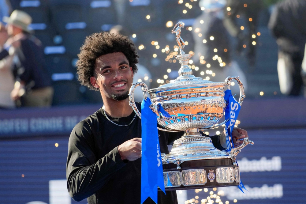  France's Arthur Fils lifts the trophy after winning the men singles final against Russia's Andrey Rublev  
