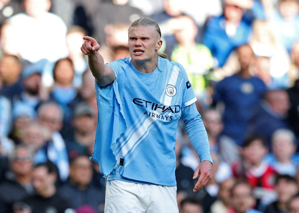  Manchester City's Erling Haaland reacts after his shirt is ripped 