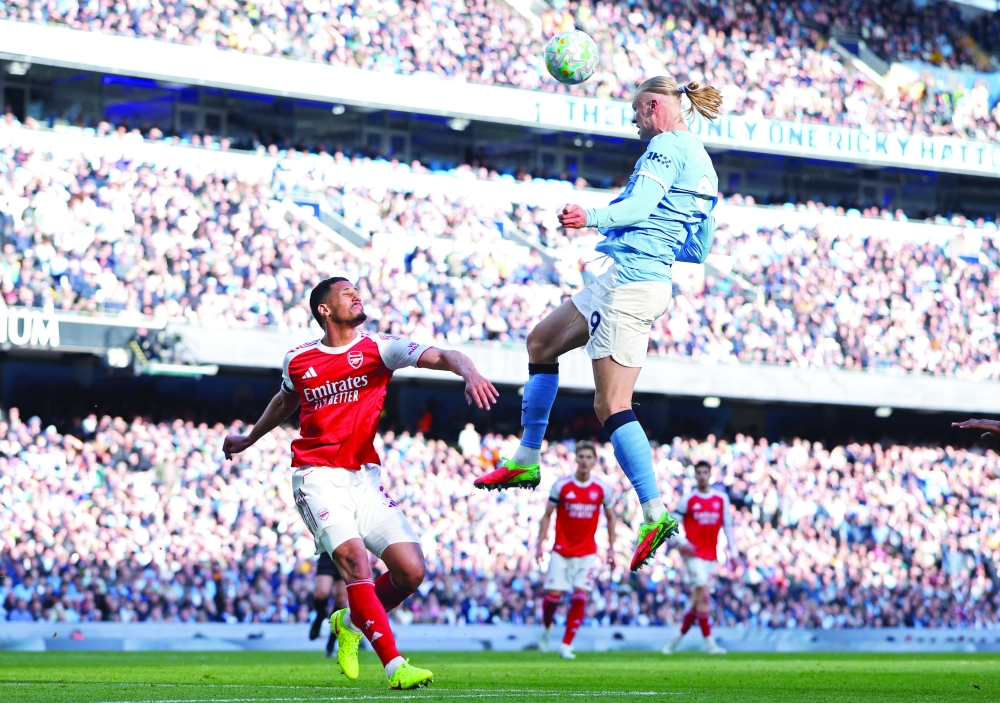 Arsenal's William Saliba in action with Manchester City's Erling Haaland. — Reuters