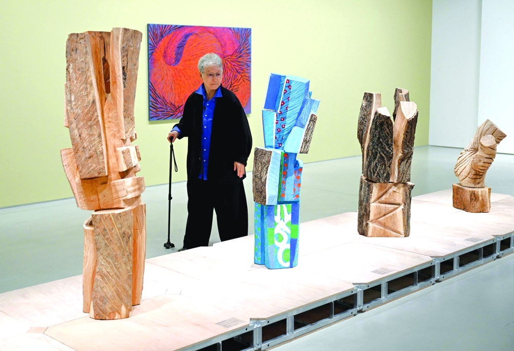 This picture taken on March 11, 2026, shows South Korean sculptor Kim Yun Shin looking at her works in her retrospective exhibition, titled "Two Be One", at Hoam Museum of Art in Yongin. In her 90s, South Korean sculptor Kim Yun Shin still wields a chainsaw with quiet focus, refining a craft she honed over decades spent far away from home. - TO GO WITH AFP STORY  SKorea-Art BY Claire LEE
