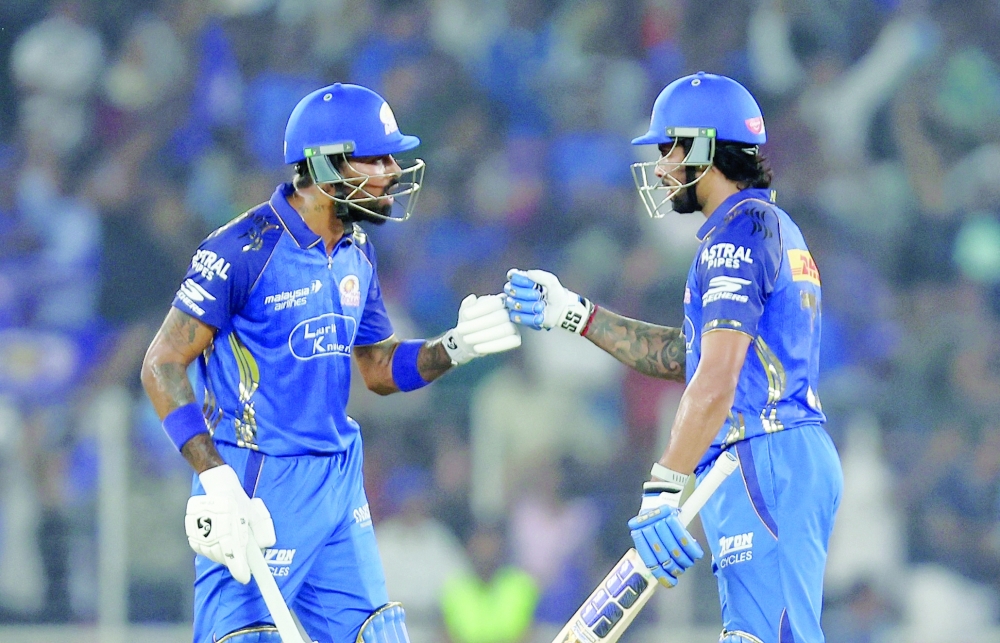 Mumbai Indians' Tilak Varma and Mumbai Indians' Hardik Pandya react during the match. — Reuters