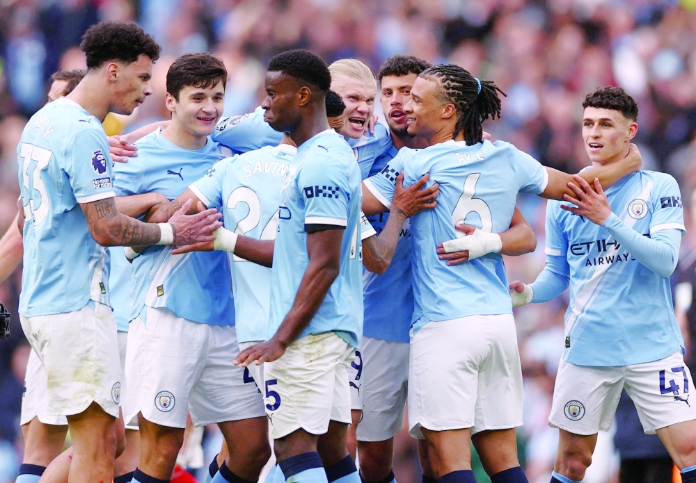 Manchester City's Erling Haaland with teammates celebrate after the match against Arsenal at  Etihad Stadium, Manchester, Britain. — Reuters