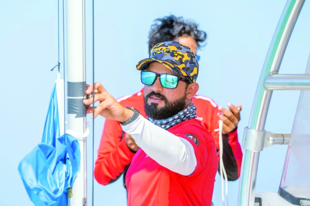 Nawaf al Ghadani measures wind speed during an event.